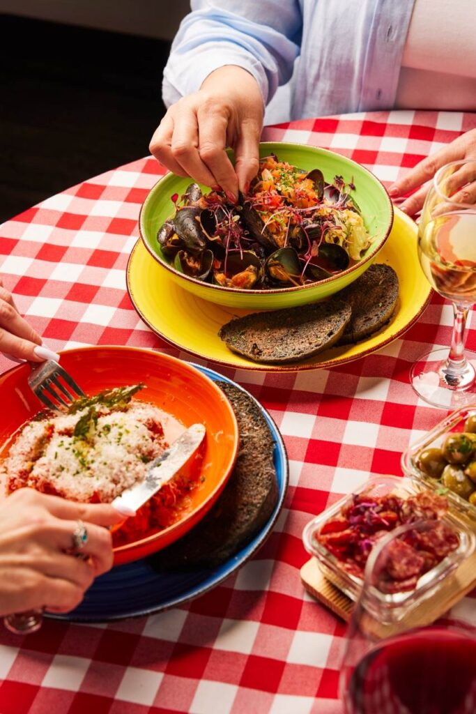 Close-up of guests enjoying classic Italian seafood and pasta dishes at Mangiare Restaurant, perfect for catered events in Toronto.
