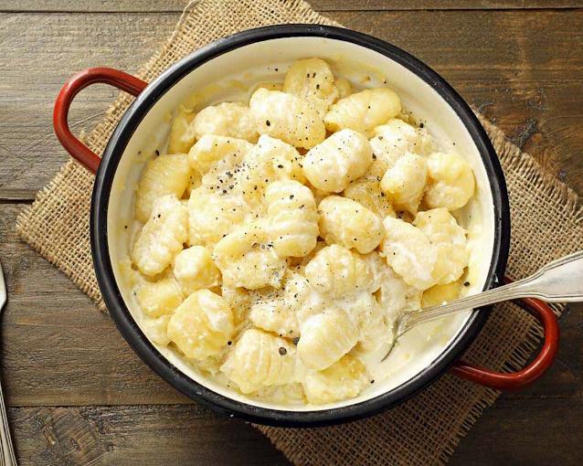 Gnocchi served with a creamy sauce, black pepper, and fresh Italian ingredients at Mangiare, Toronto's authentic Italian restaurant